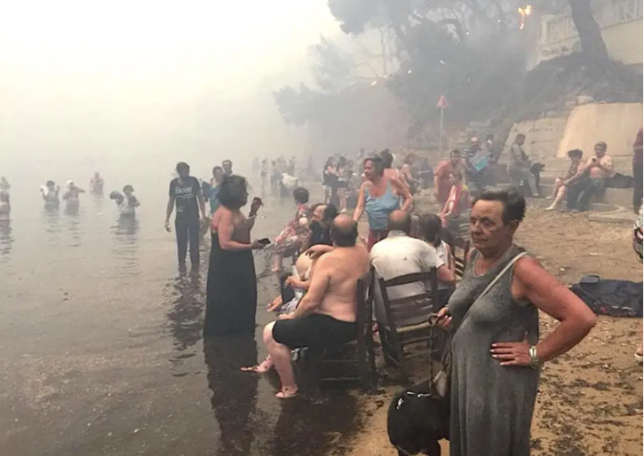 Figure 7: Residents of Mati awaiting rescue on the shore. (Source: https://www.insider.com/greece-wildfire-outside-athens-worst-since-2007-at-least-50-dead-2018-7)