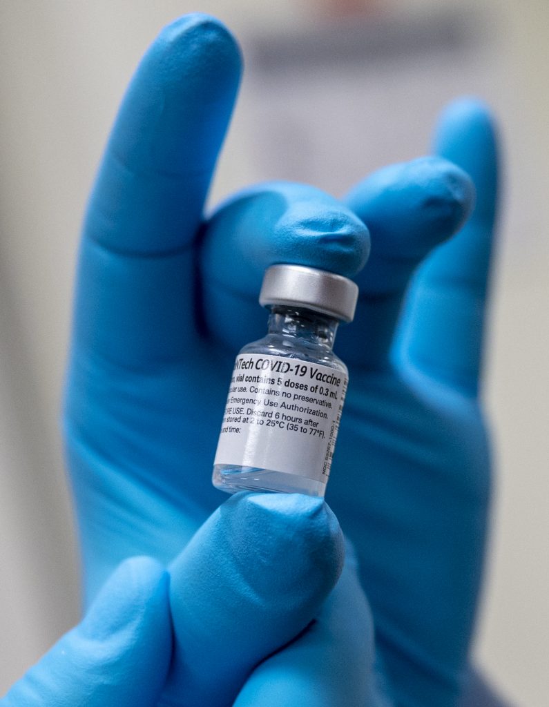 Army Spc. Angel Laureano holds a vial of the COVID-19 vaccine, Walter Reed National Military Medical Center, Bethesda, Md., Dec. 14, 2020. (DoD photo by Lisa Ferdinando)