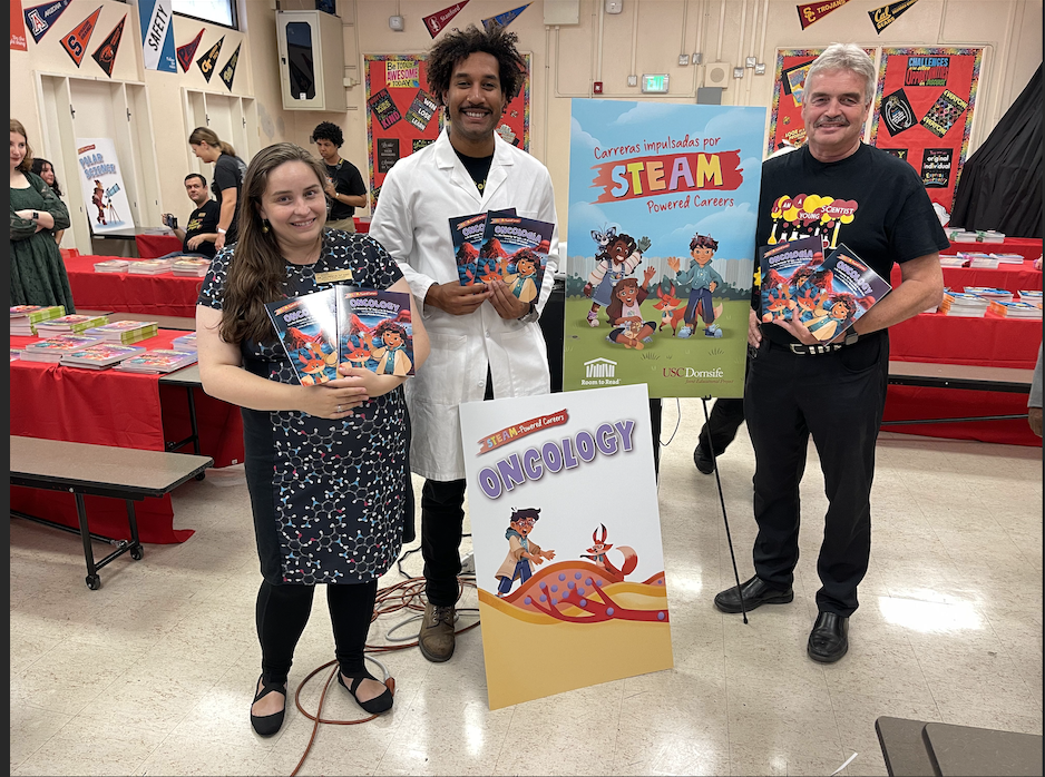 figure-1-authors-dr-dieuwertje-kast-dr-w-martin-kast-and-featured-scientist-dj-fernandez-hold-their-english-and-spanish-copies-of-their-oncology-book-that-was-showcased-at-the-book-assemblies-photo-by-dieuwe